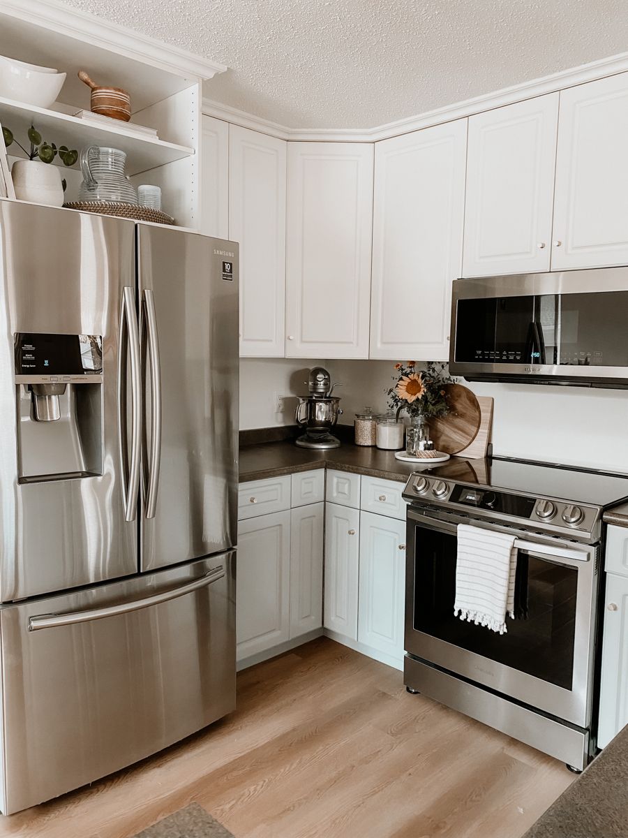 Stainless appliance upgrades and modern range controls in a Texas kitchen remodel
